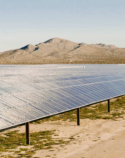 A solar panel with a mountain in the background.