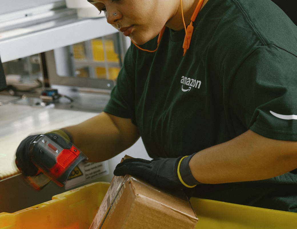 A person is shown scanning a carboard box. 