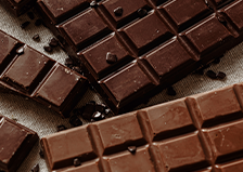 Several chocolate bars sit atop a table.