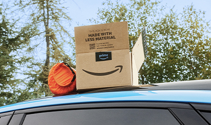 An Amazon box is shown sitting on top of a car.