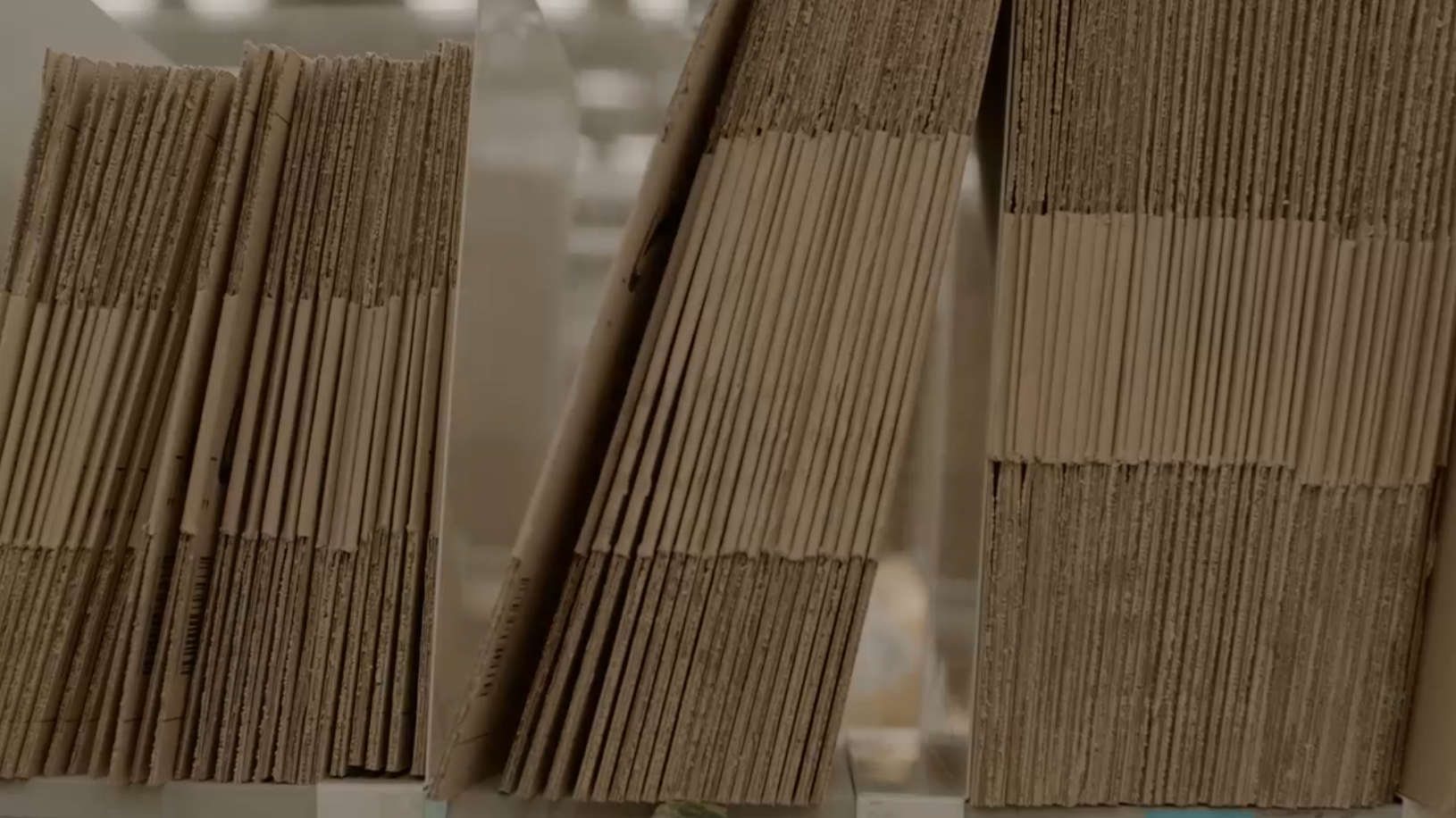 Neatly folded stacks of cardboard boxes are shown above text that says: "Internal waste explained."